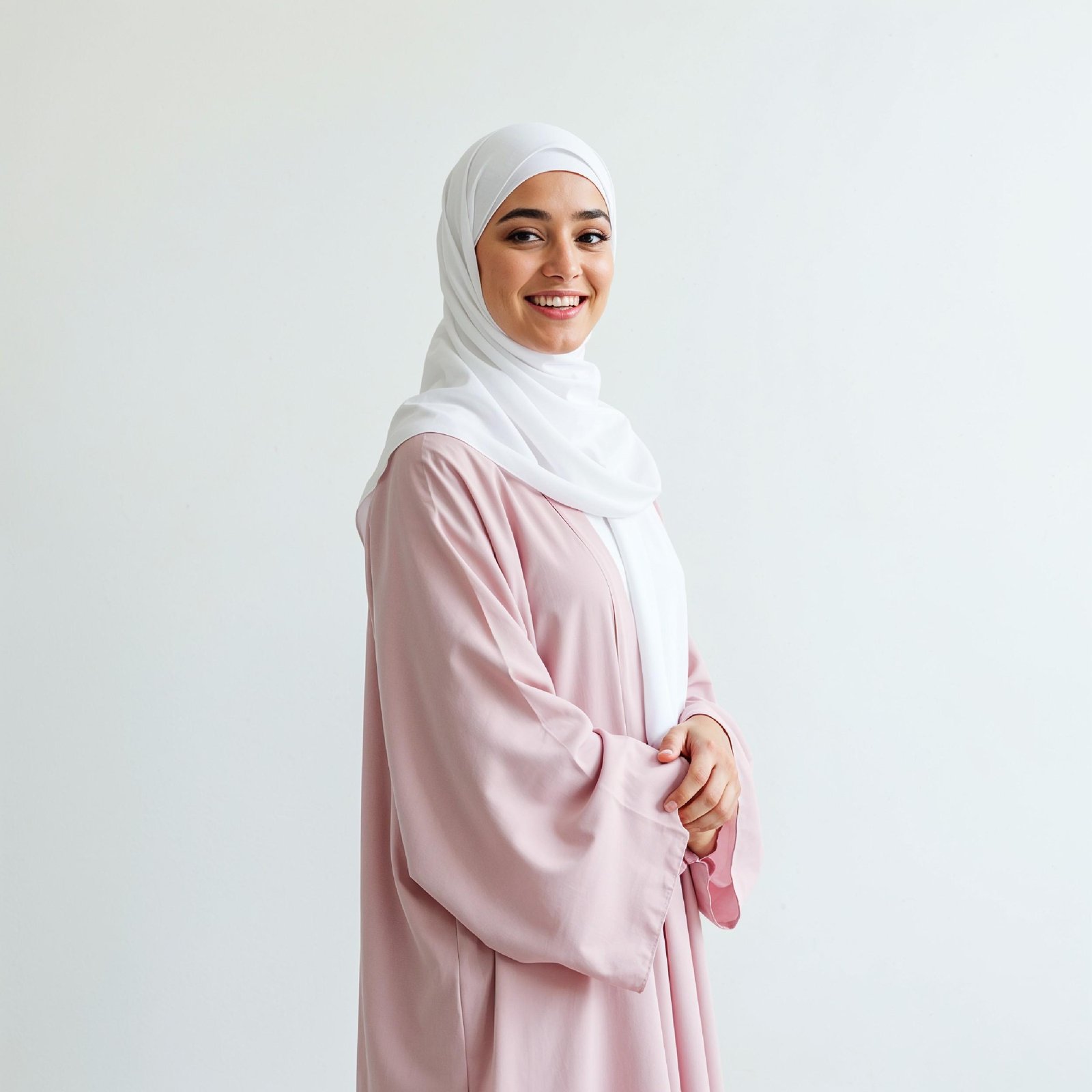 Beautiful Young Muslim Woman Wearing White Hijab and Modest Dress in Studio Portrait
