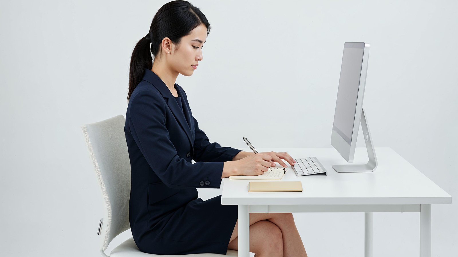 Beautiful Young Woman Working on Laptop at Modern Office Desk, Professional Business Portrait