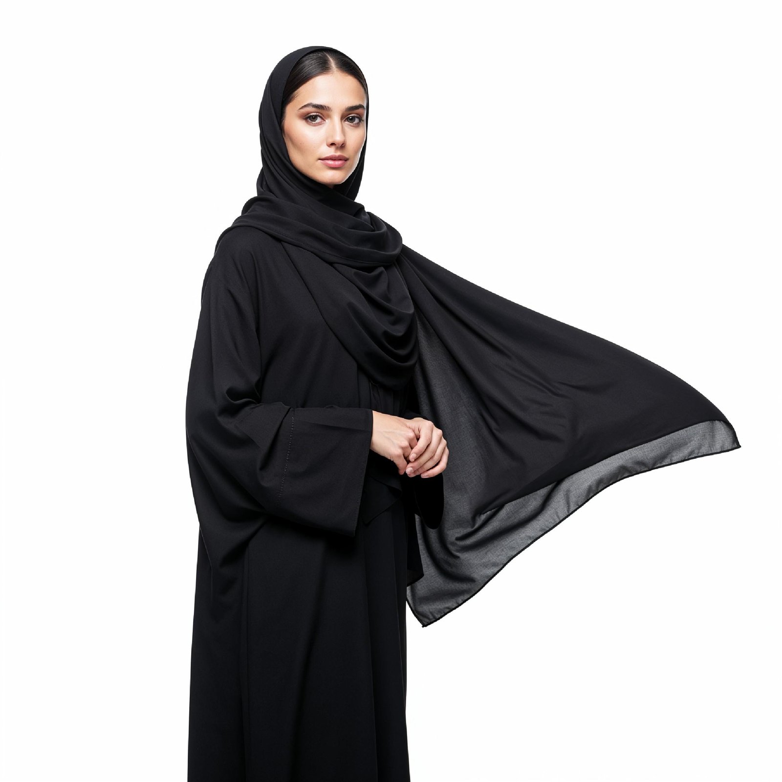 Elegant Muslim Woman Wearing Black Hijab and Abaya in Studio Portrait on Light Background