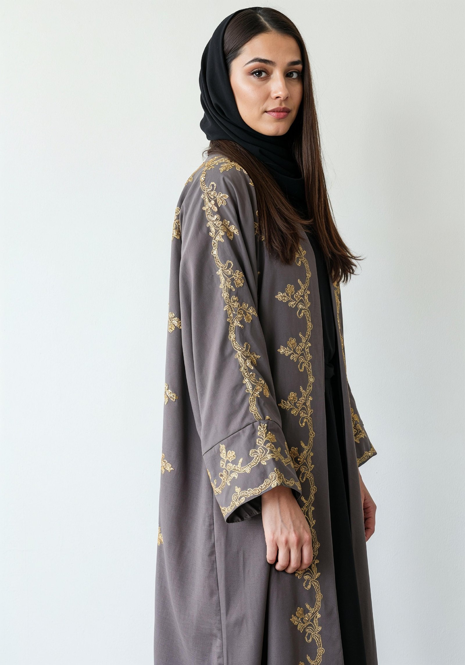 Elegant Muslim Woman Wearing Luxury Black and Gold Embroidered Abaya