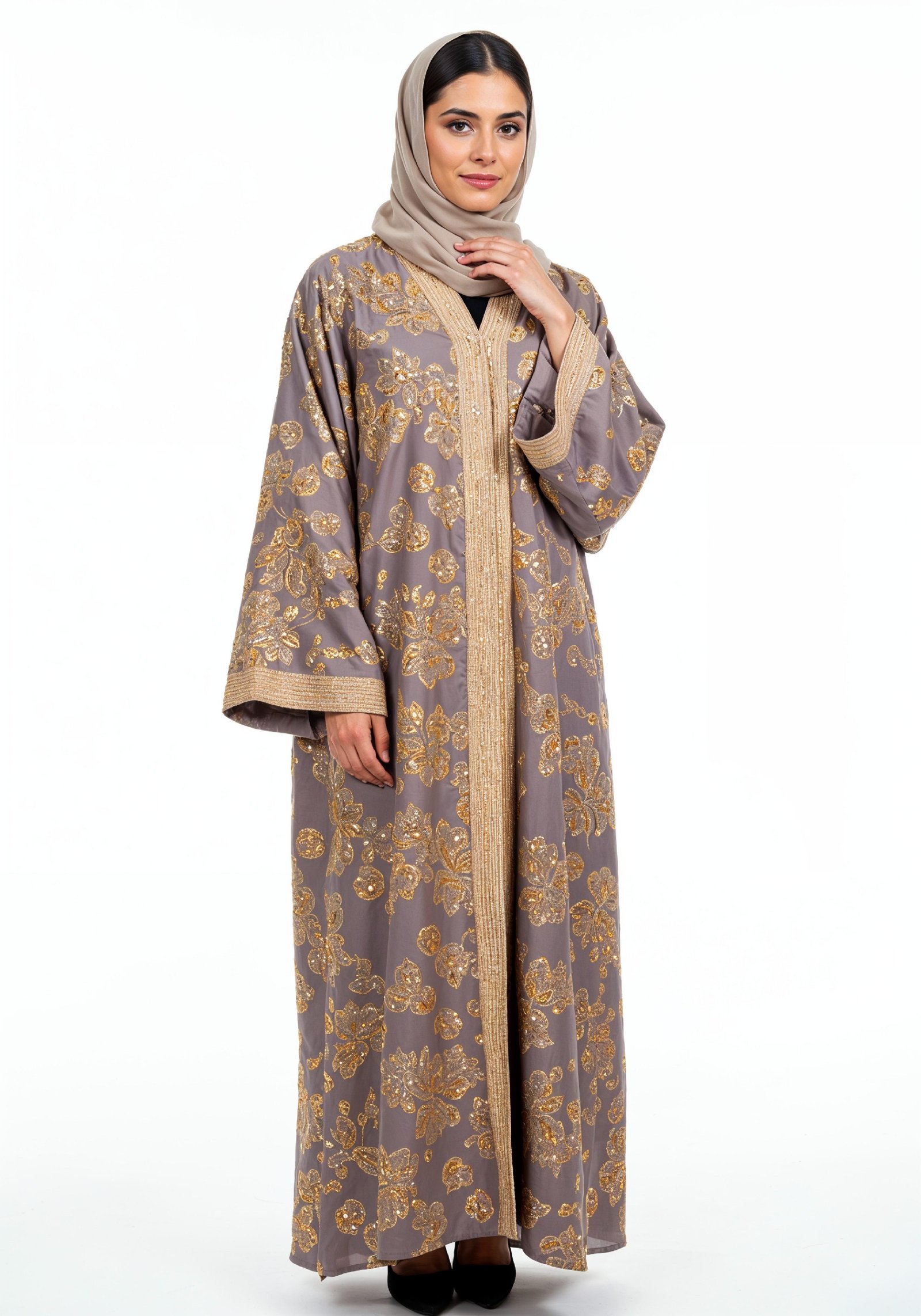 Elegant Muslim Woman Wearing Luxury Black and Gold Embroidered Abaya
