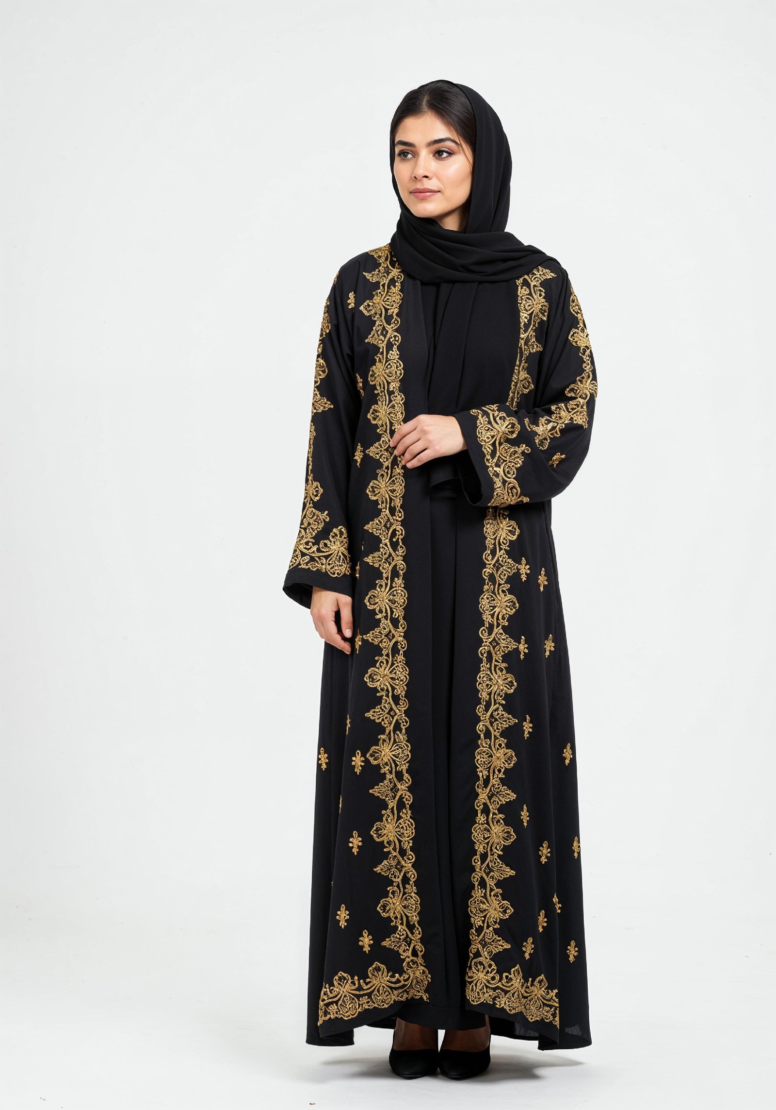 Elegant Muslim Woman Wearing Luxury Black and Gold Embroidered Abaya