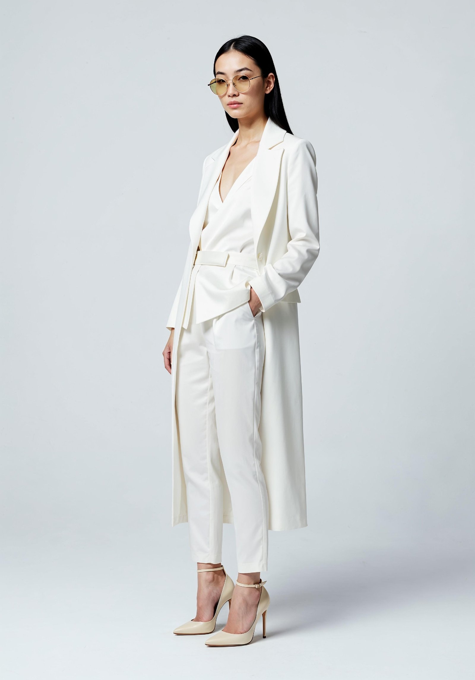 Elegant Young Woman in Coat and Matching Trousers Fashion Portrait