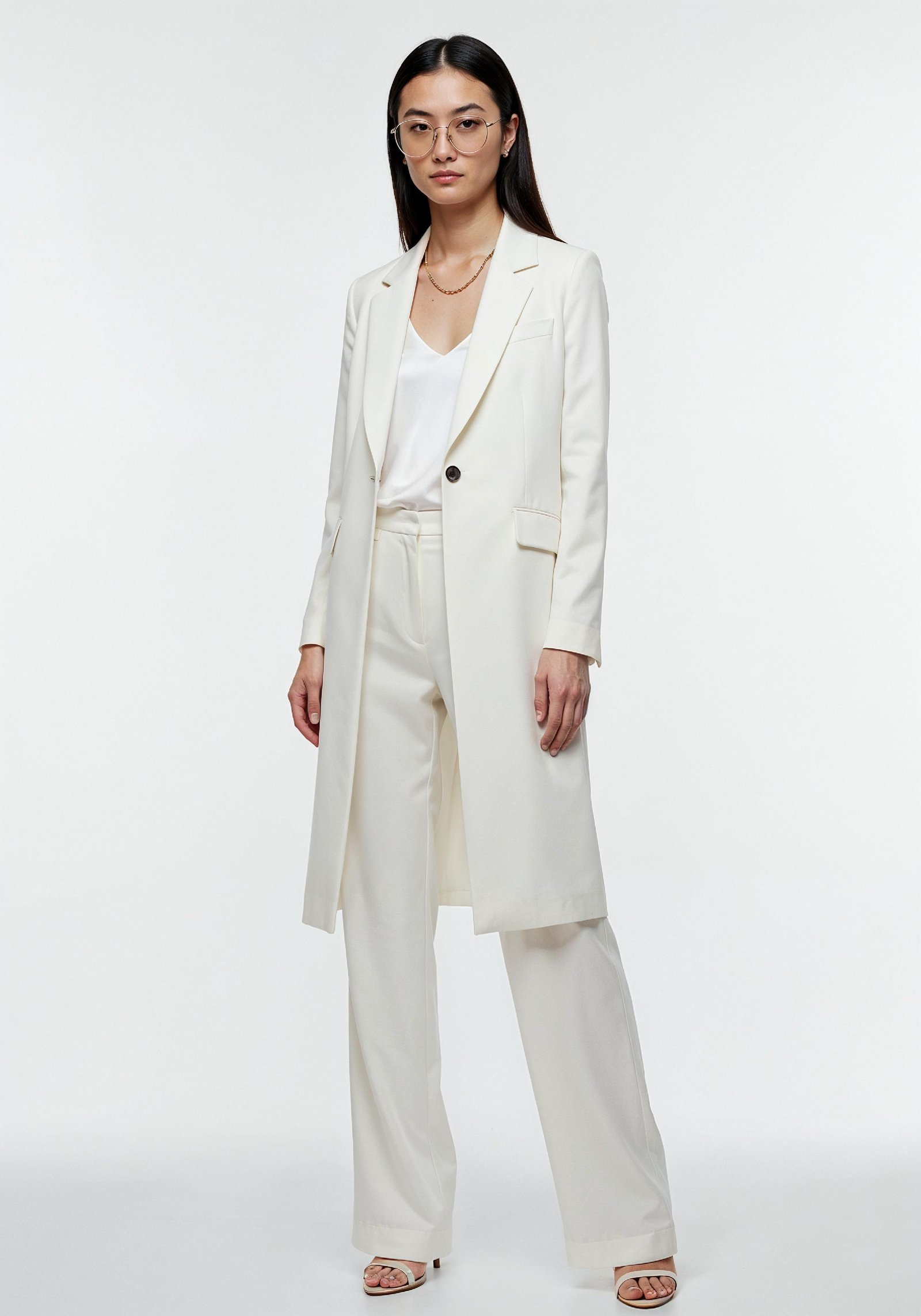 Elegant Young Woman in Coat and Matching Trousers Fashion Portrait