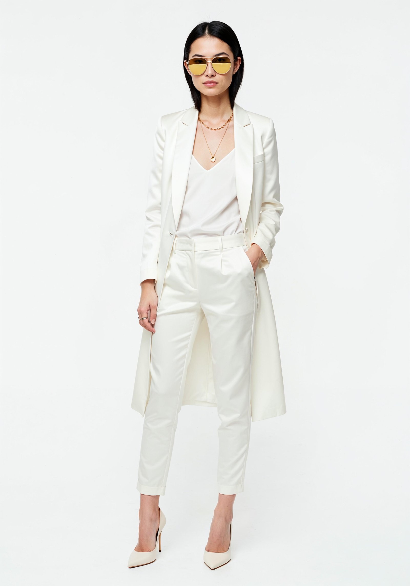 Elegant Young Woman in Coat and Matching Trousers Fashion Portrait