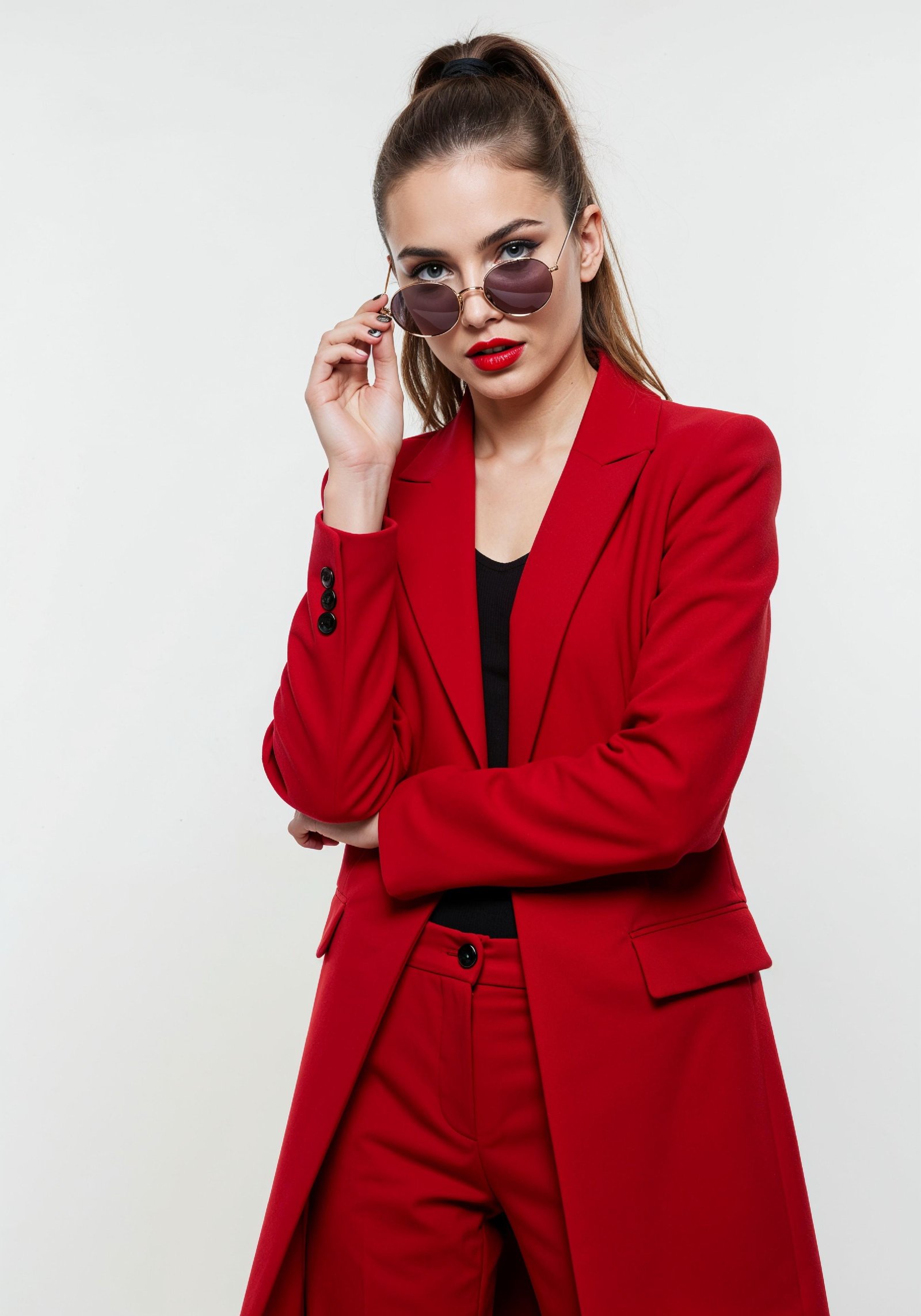 Elegant Young Woman in Coat and Matching Trousers Fashion Portrait