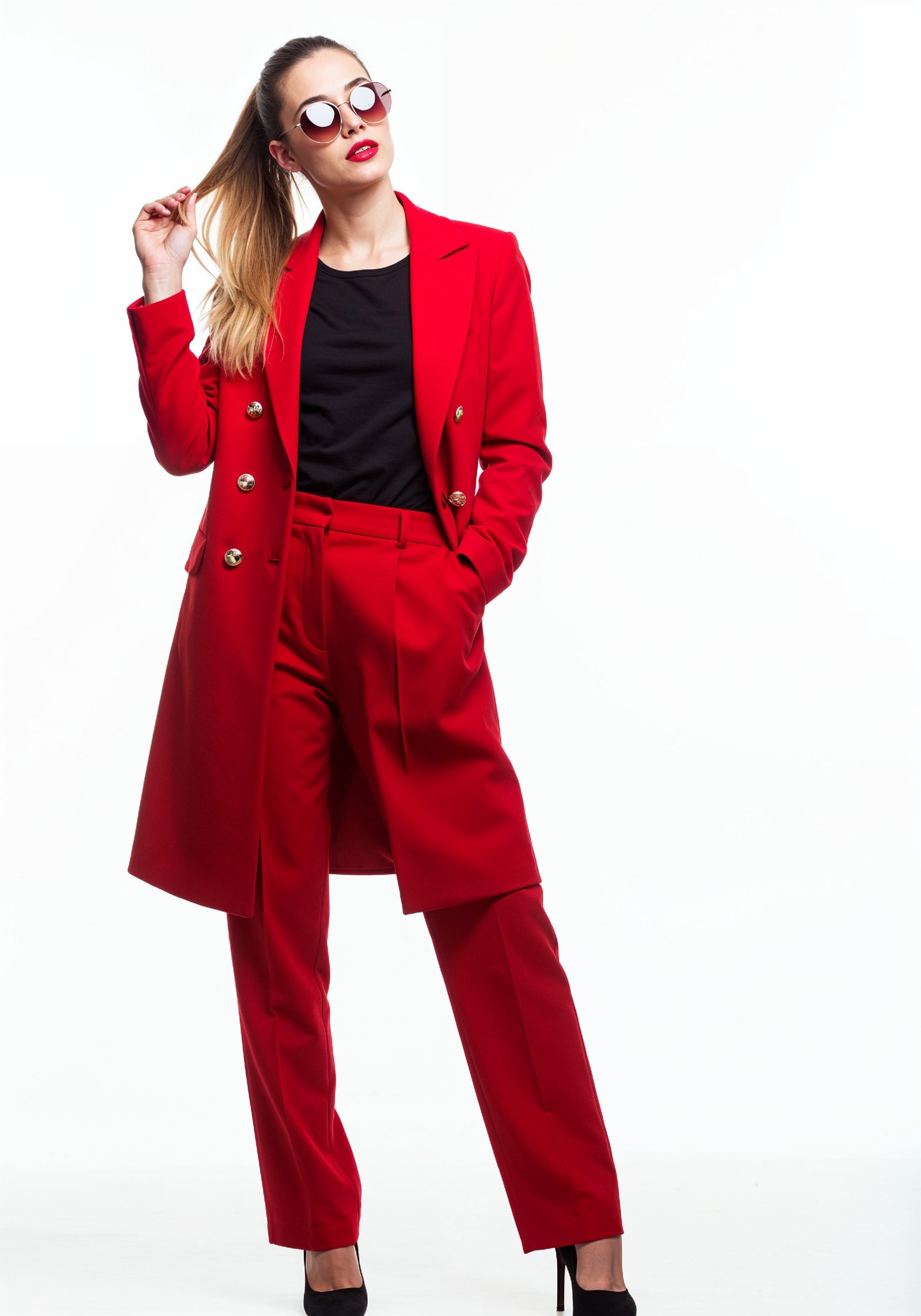 Elegant Young Woman in Coat and Matching Trousers Fashion Portrait