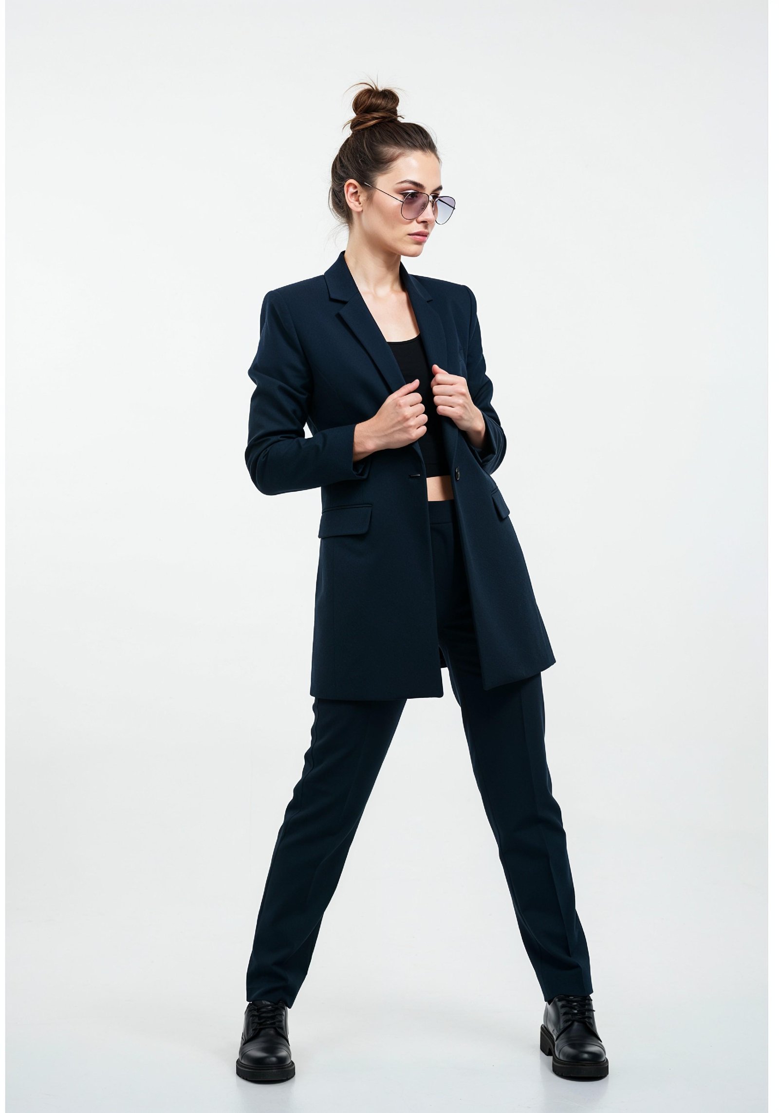 Elegant Young Woman in Coat and Matching Trousers Fashion Portrait