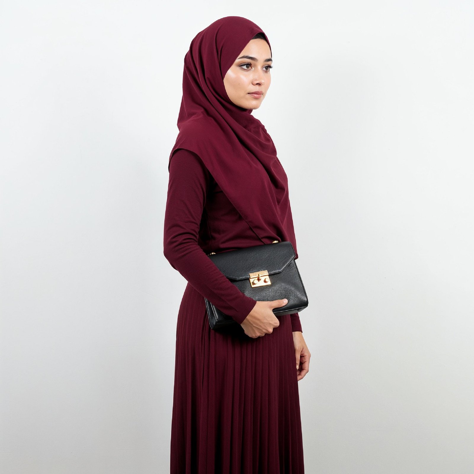 Fashionable Muslim Woman Wearing Maroon Hijab and Elegant Modest Outfit with Handbag