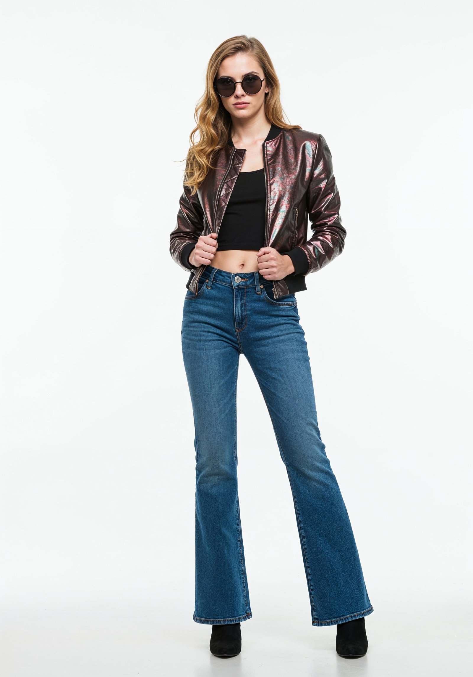 Fashionable Young Woman in Metallic Bomber Jacket and Flared Jeans Street Style Portrait