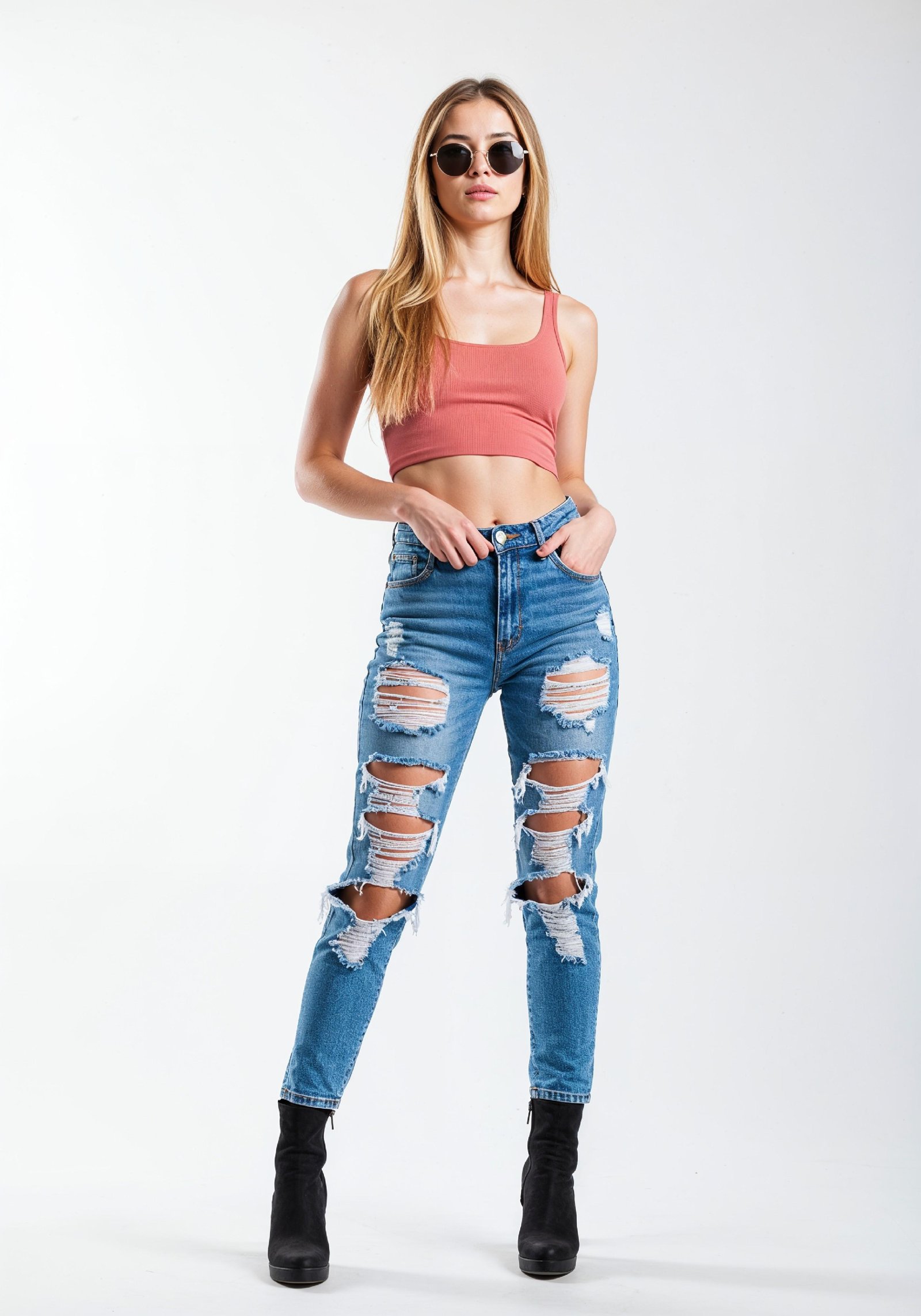 Fashionable Young Woman in Ripped Skinny Jeans and Crop Top Casual Street Style Portrait