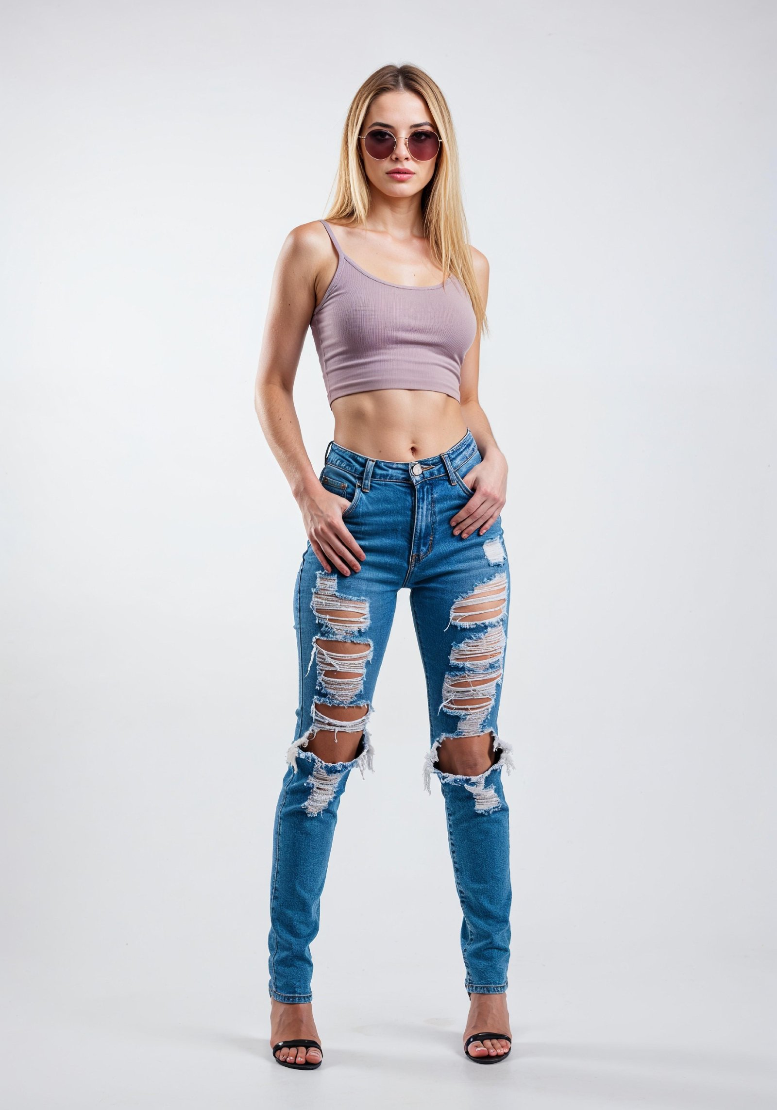 Fashionable Young Woman in Ripped Skinny Jeans and Crop Top Casual Street Style Portrait