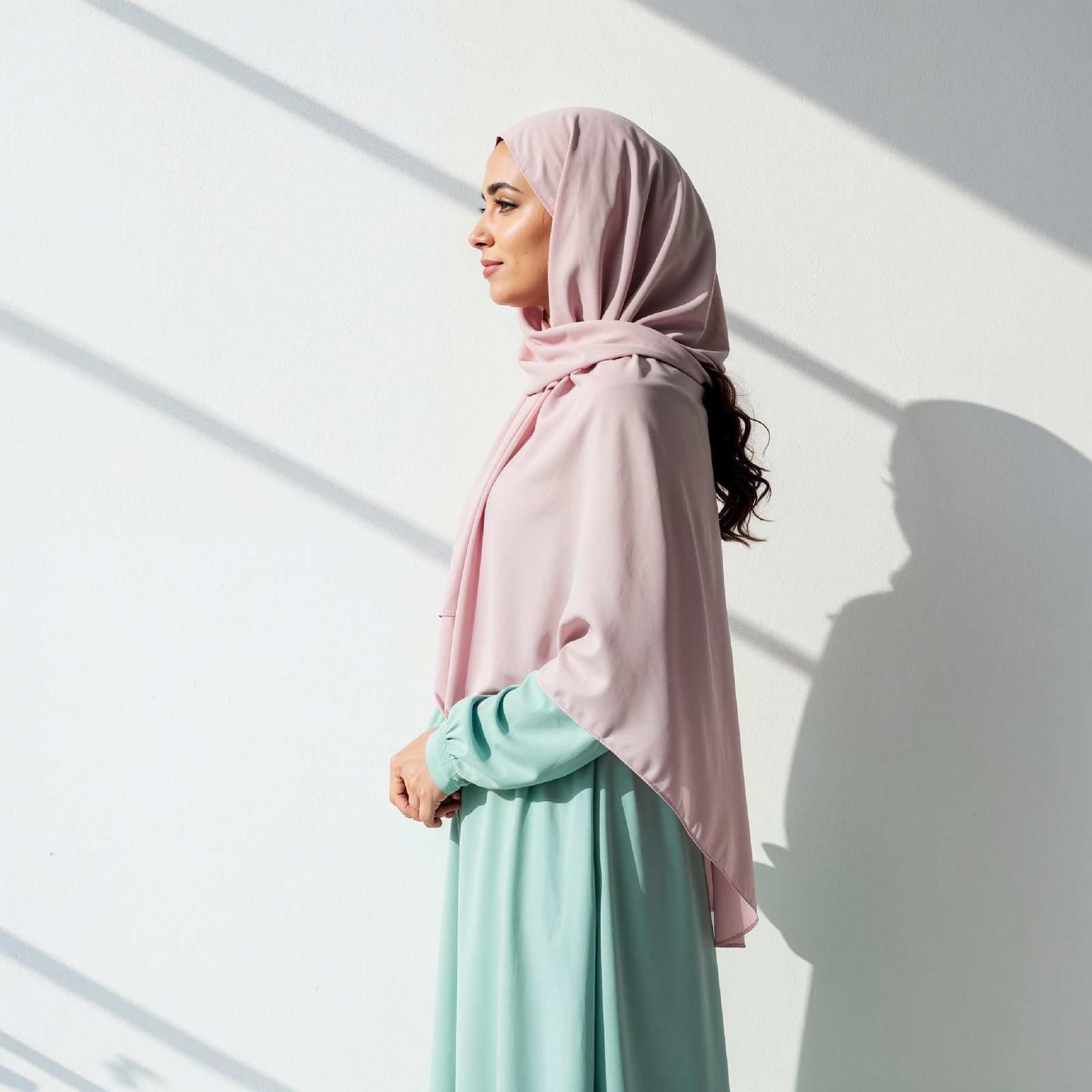 Graceful Young Muslim Woman Wearing Pastel Hijab and Elegant Modest Dress in Studio Portrait