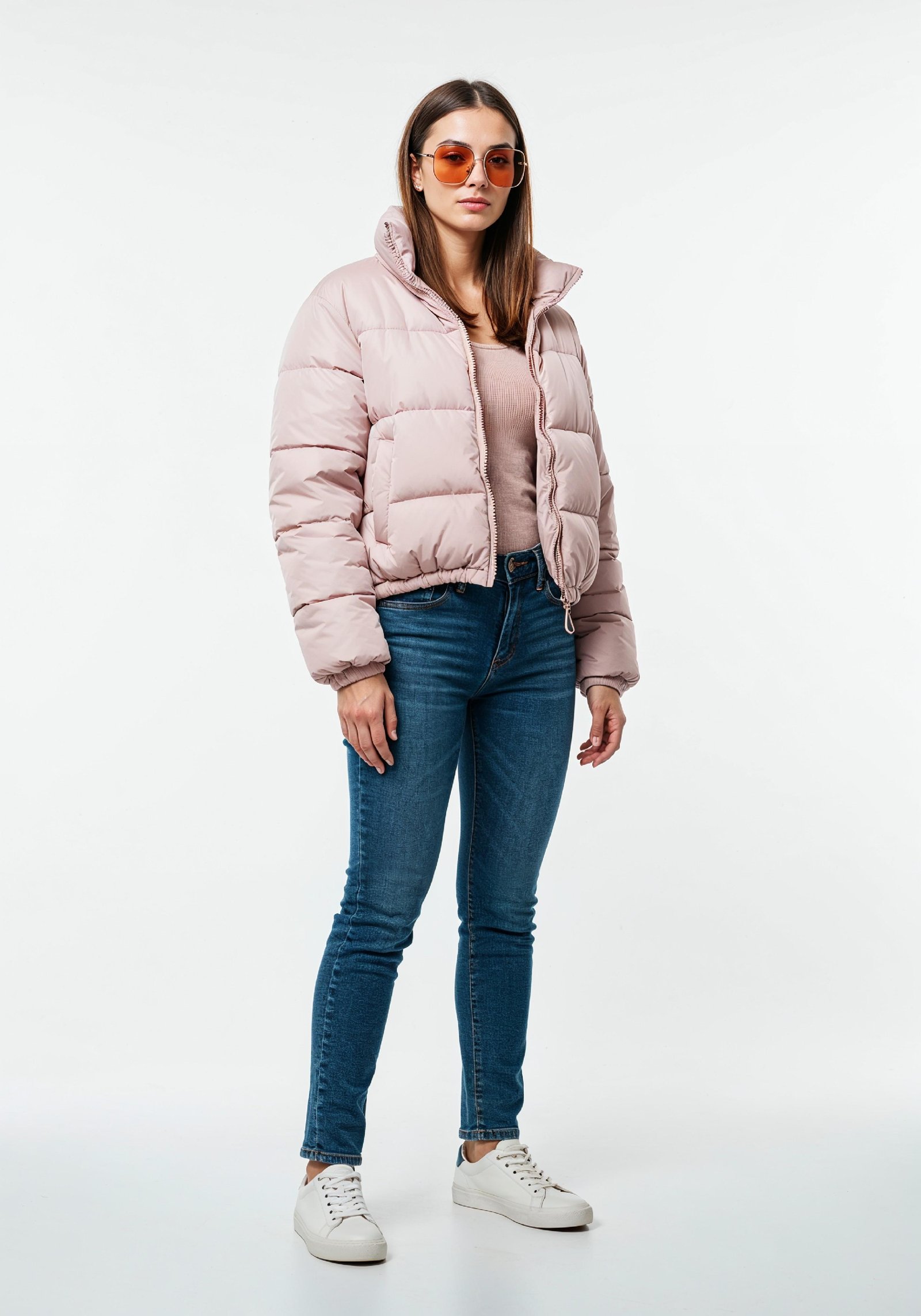 Stylish Young Woman in Pink Puffer Jacket and Blue Jeans Winter Fashion Portrait
