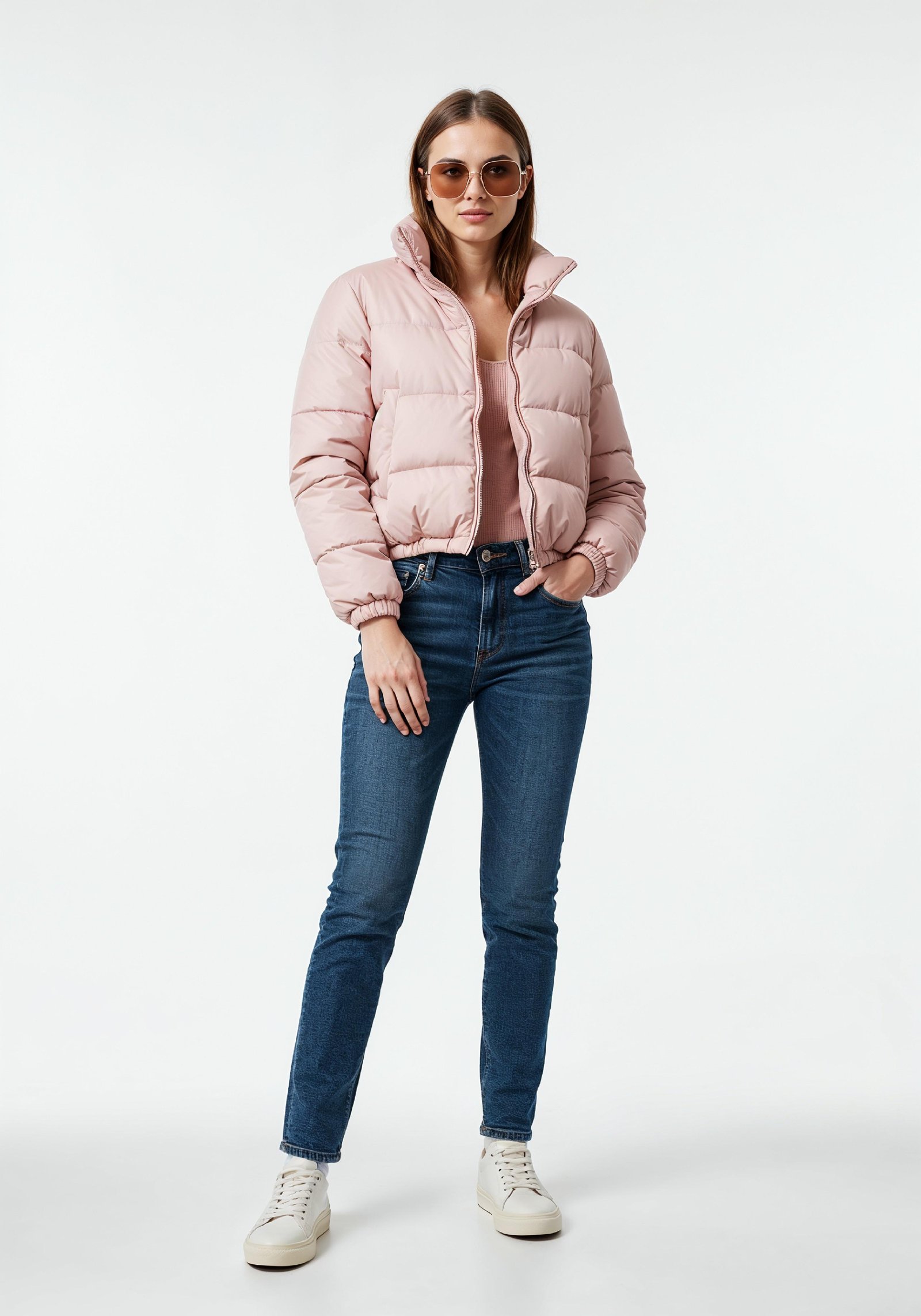 Stylish Young Woman in Pink Puffer Jacket and Blue Jeans Winter Fashion Portrait