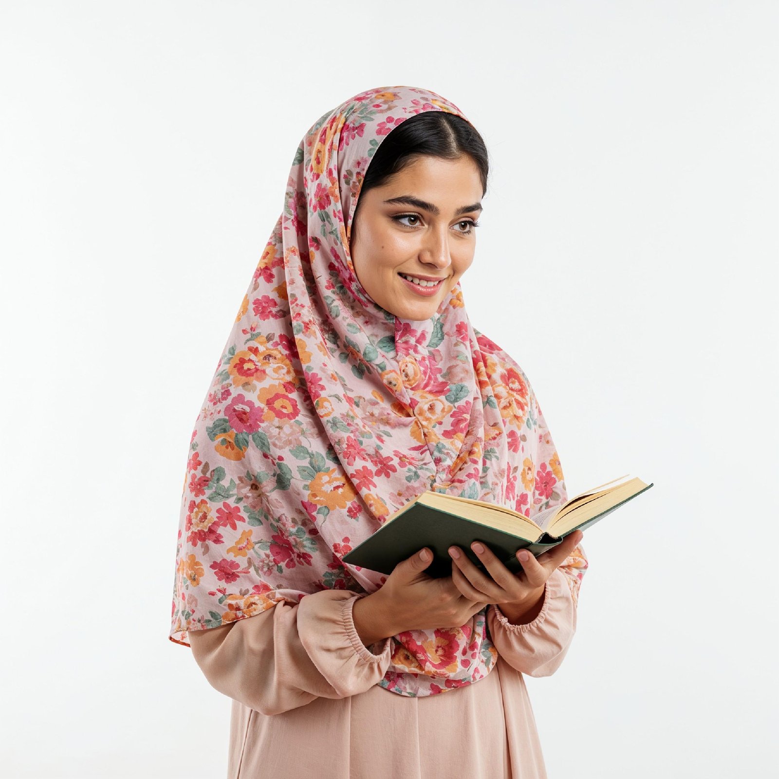 Young Muslim Woman Reading Holy Quran Wearing Colorful Floral Hijab in Studio Portrait