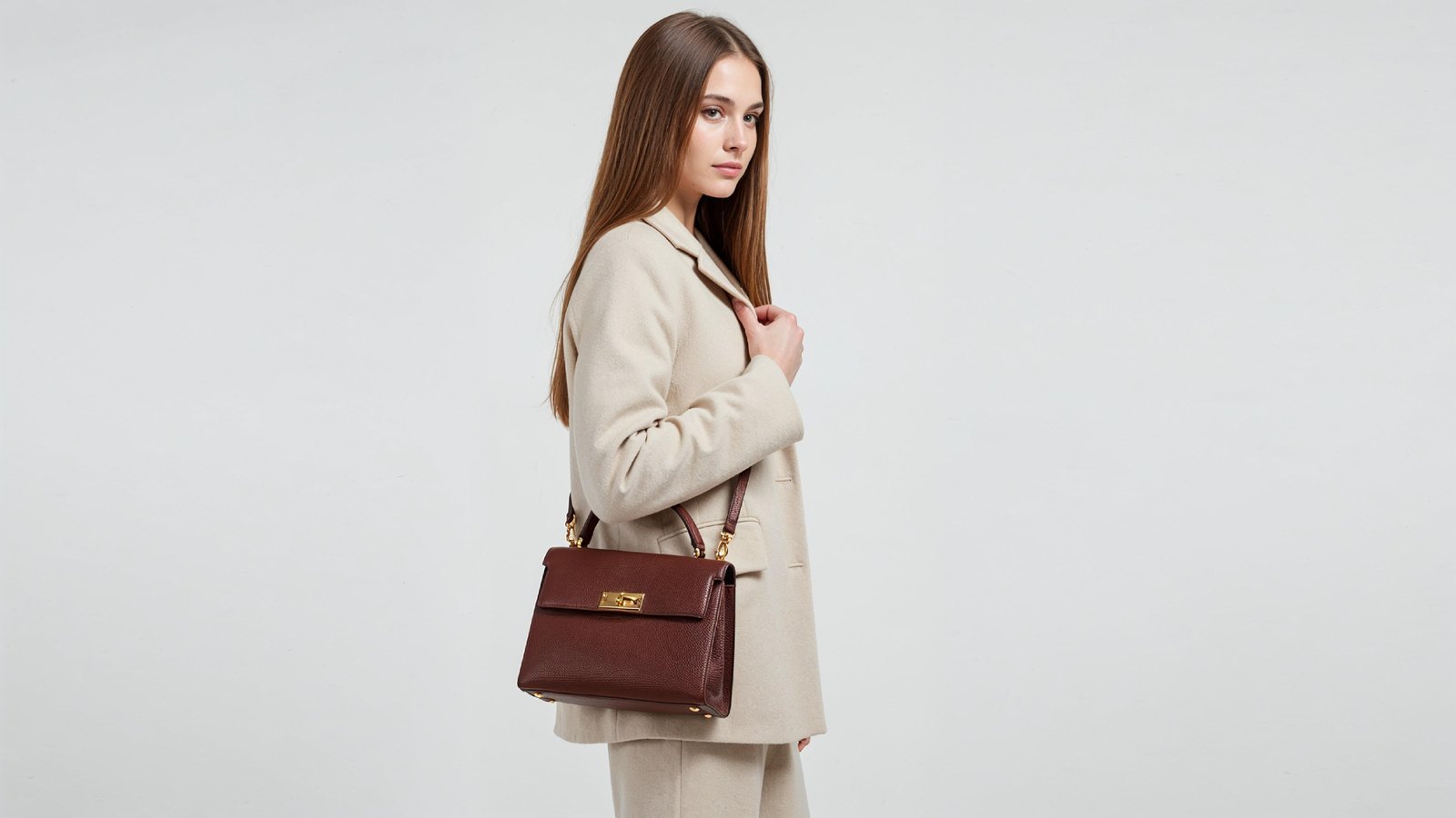 Trendy Young Woman Wearing Cream Coat Pant Suit with Leather Handbag